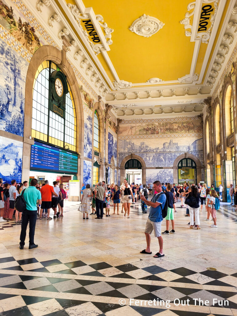 Blue and white tiles cover the interior of Sao Bento Railway Station in Porto, Portugal