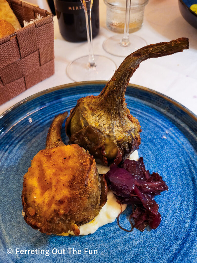 Fried artichokes with pickled red onions and parmesan polenta at Ristorante di San Pietro in Bologna, Italy