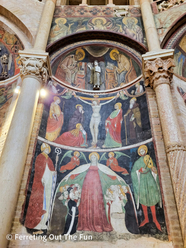 Medieval frescoes and pink marble columns in Parma Baptistry, Italy