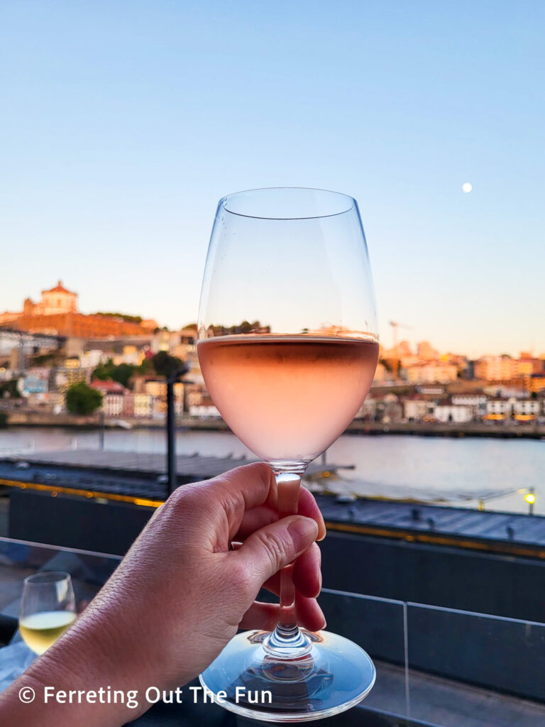 Drinking wine at sunset by the Douro River in Porto, Portugal