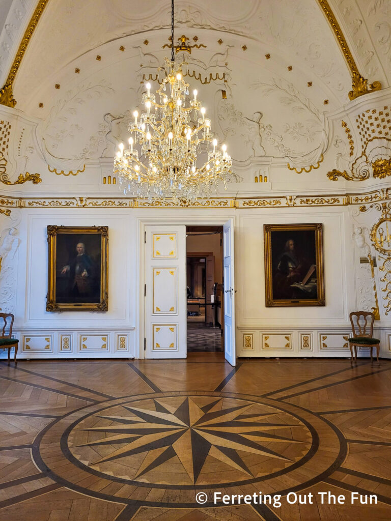 Beautiful white stucco and gilt walls and inlaid parquet floors inside Aachen Town Hall